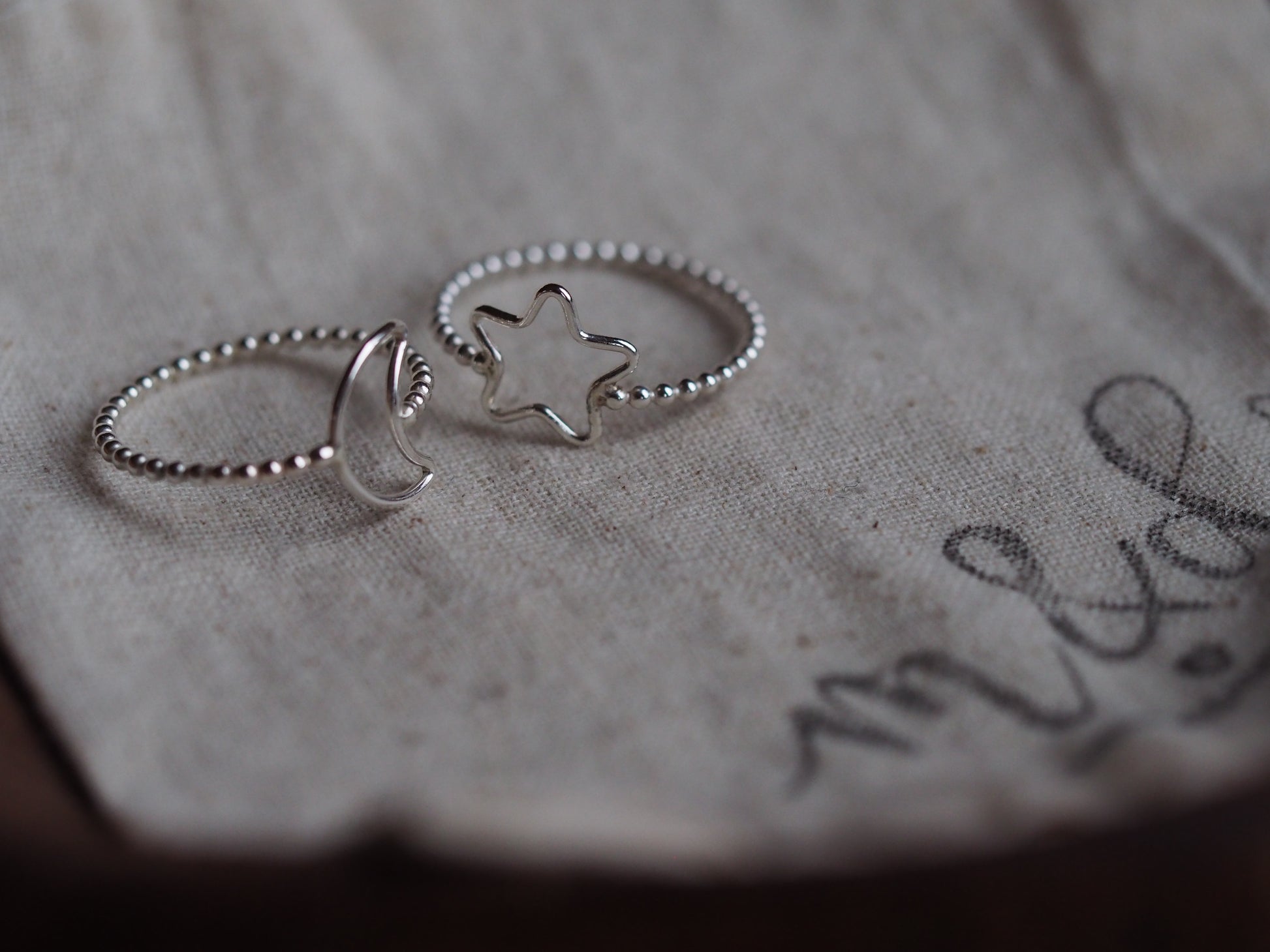 silver beaded rings with moon and star detail