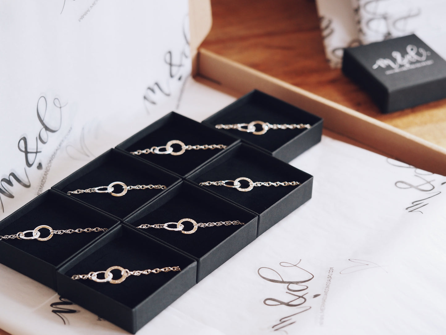 multiple interlinked bracelets showcased in gift boxes