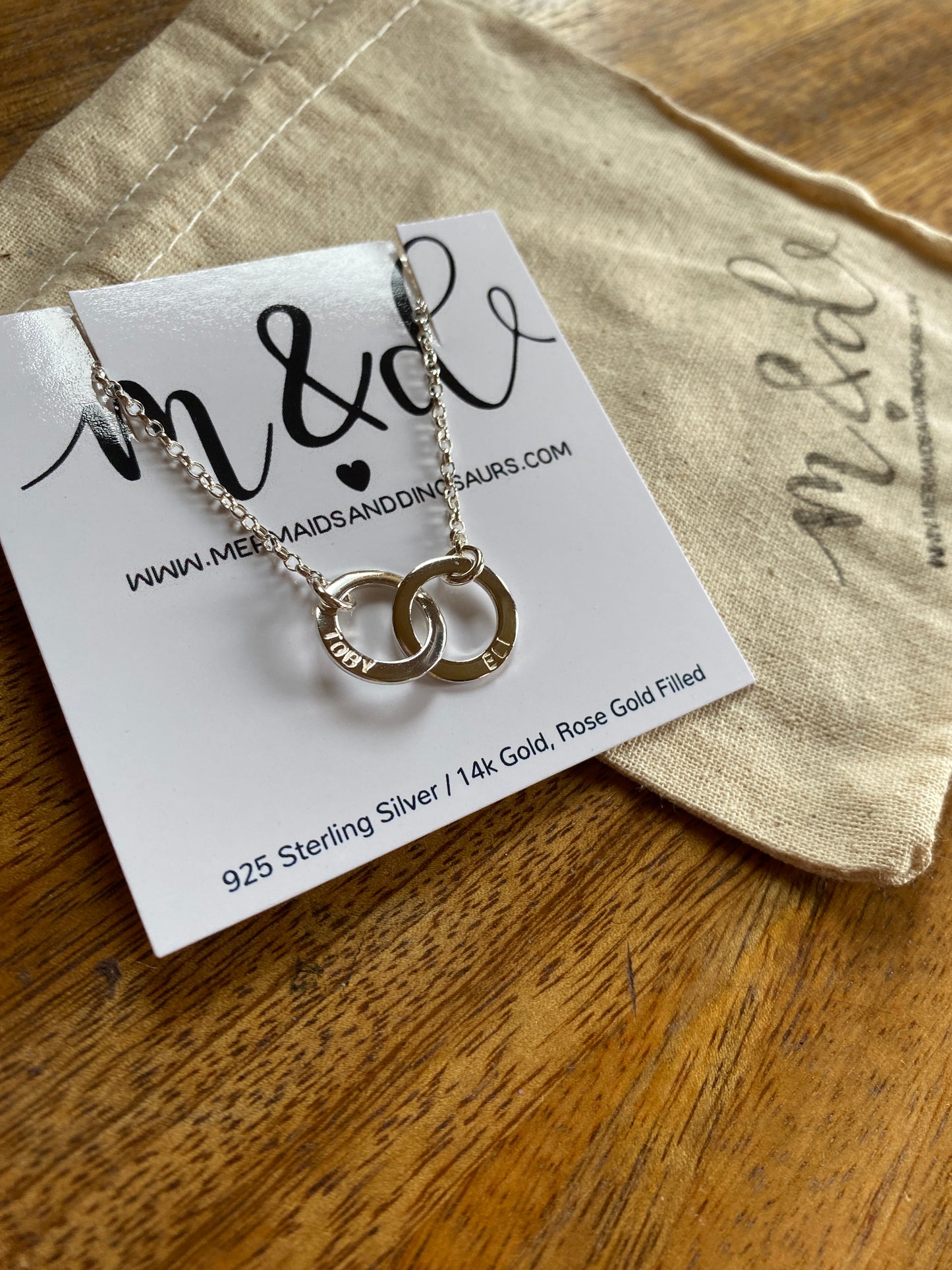silver personalised necklace on branded packaging