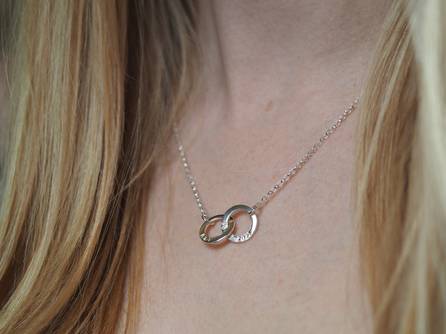 18" silver interlinked necklace being worn around neck