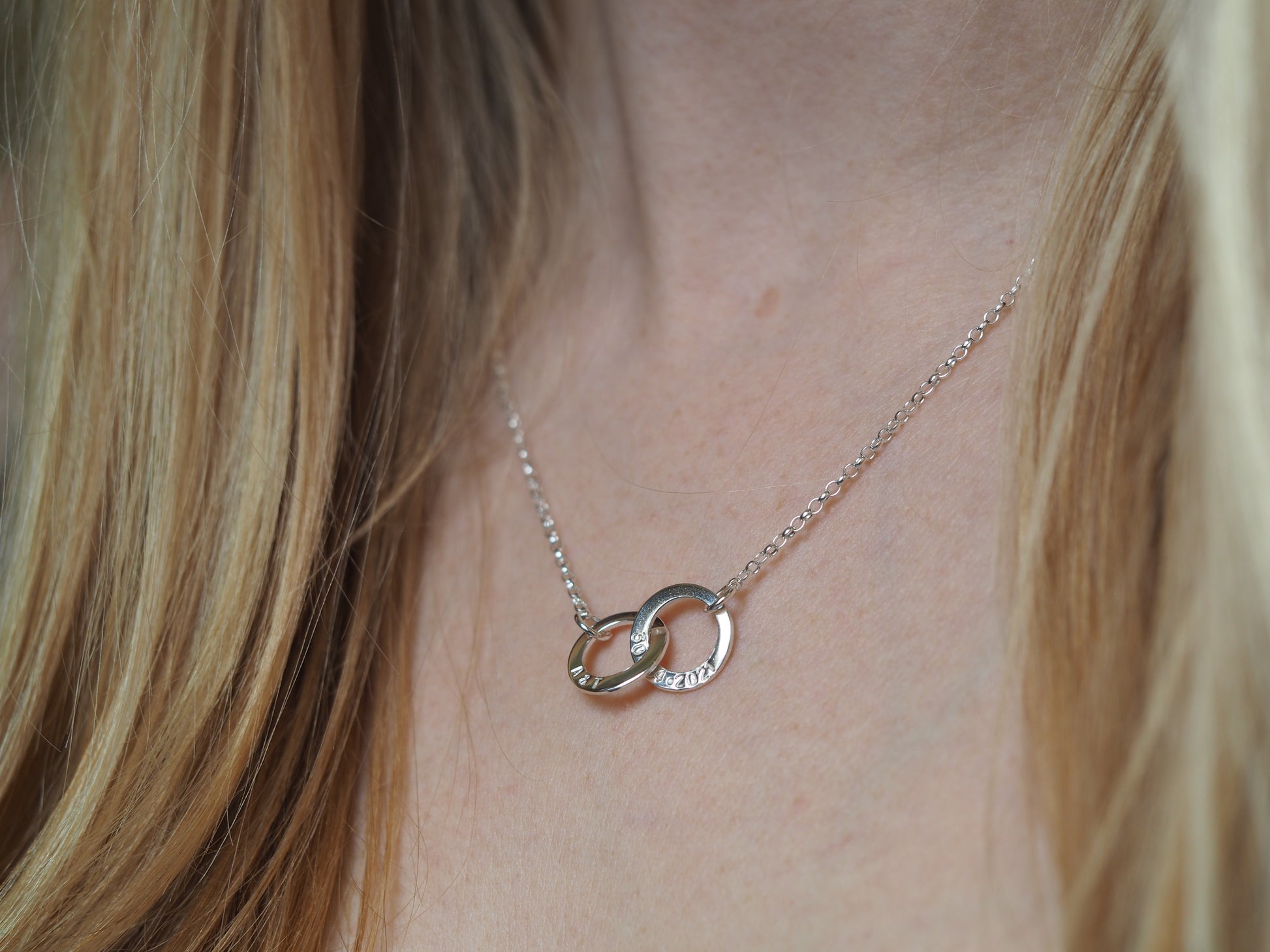 18" silver interlinked necklace being worn around neck