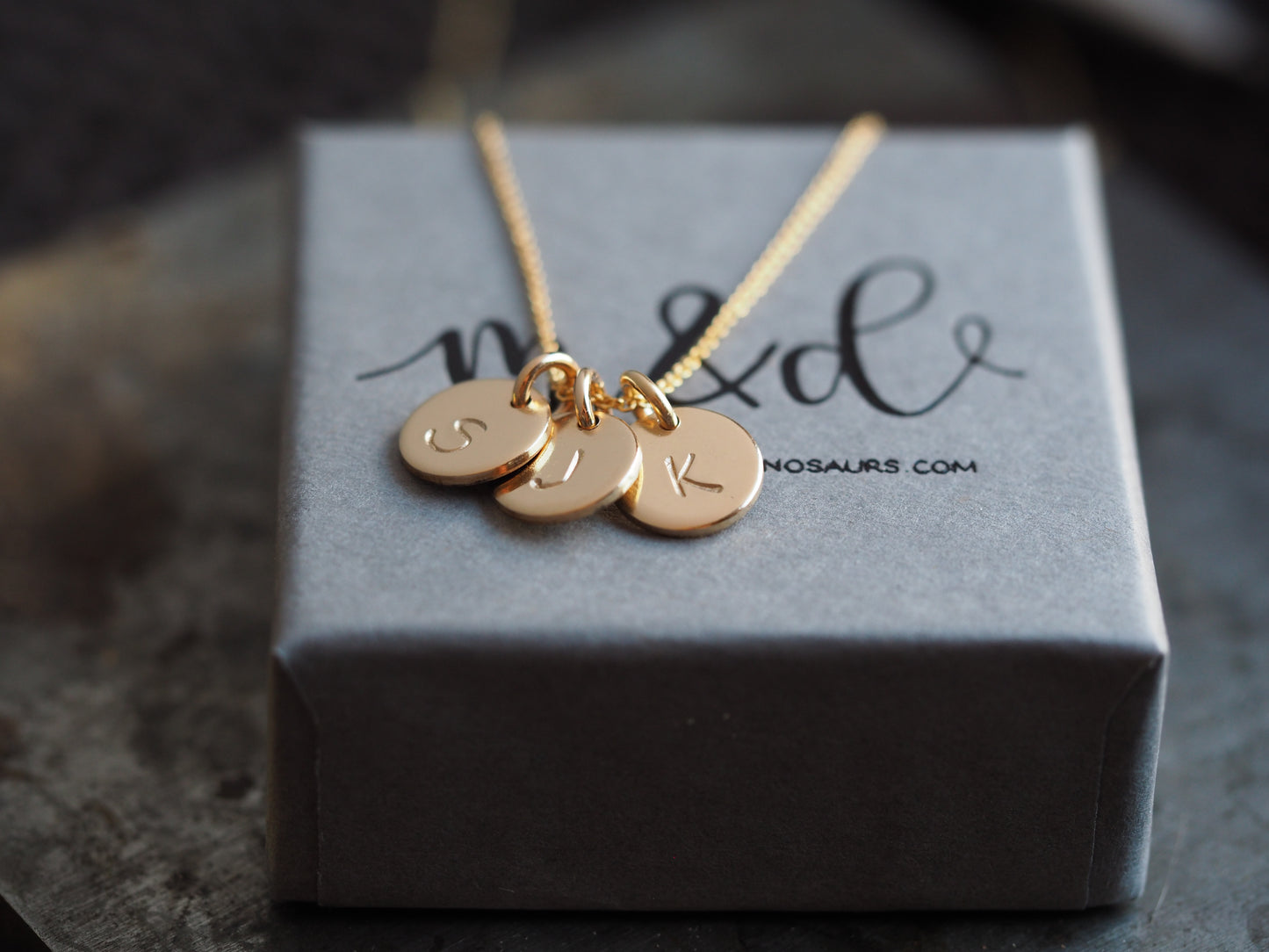 3 discs gold filled initial necklace on a gift box