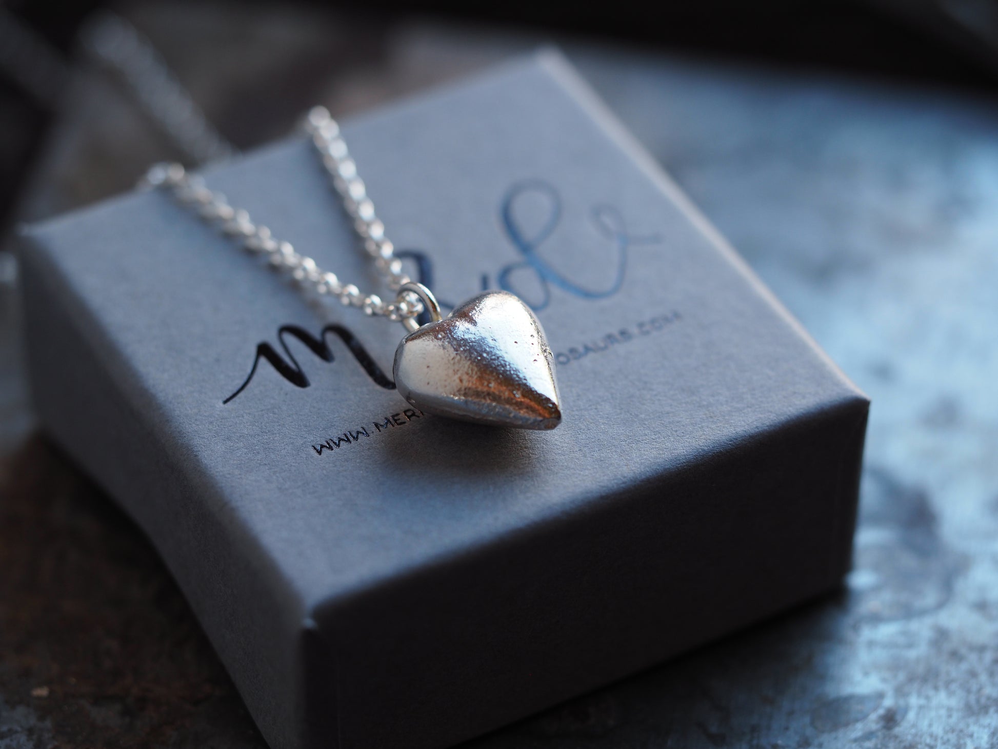 solid silver heart pendant on grey box